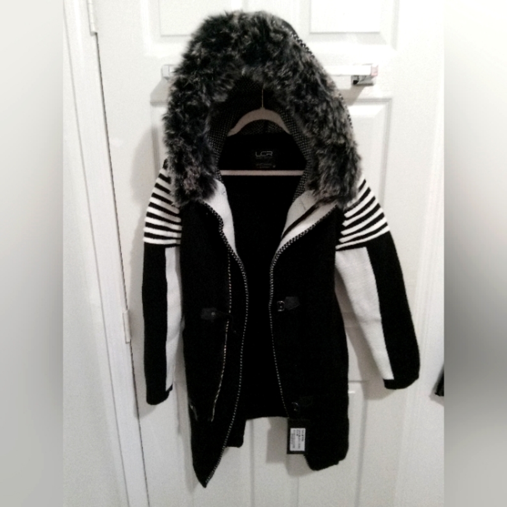 Woman's winter coat.  Medium size, and in black and white stripes on the sleeves
